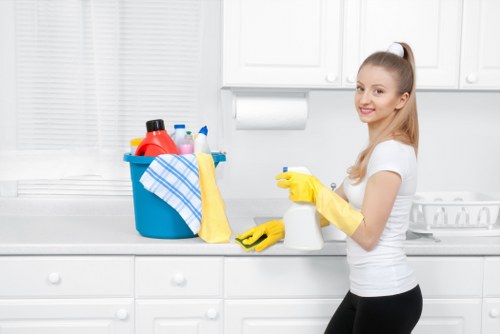 Staff member using protective gloves and footwear during carpet cleaning